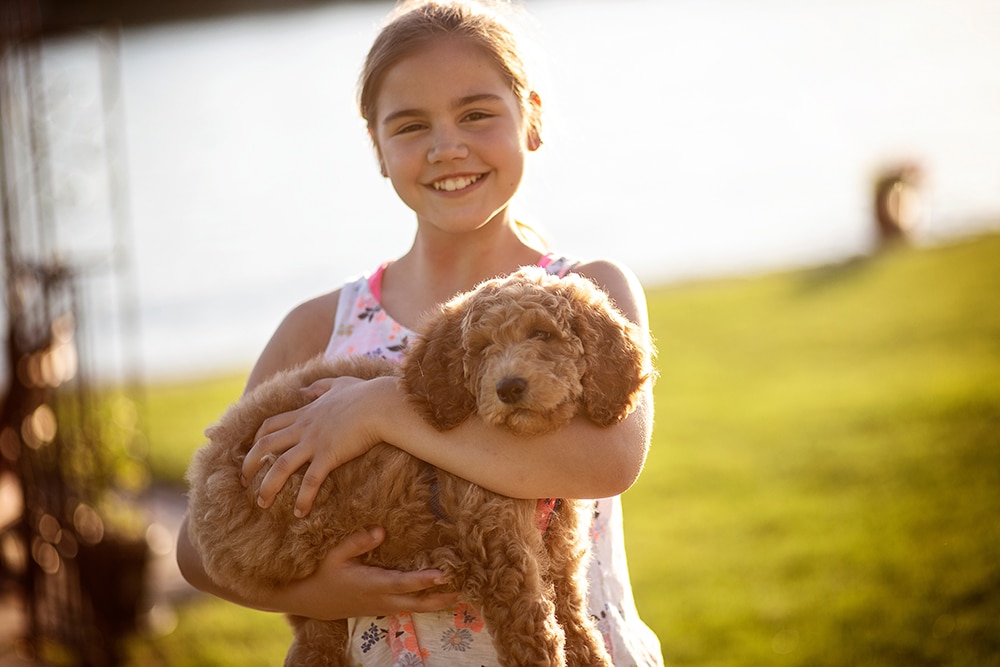 young-girl-holding-puppy